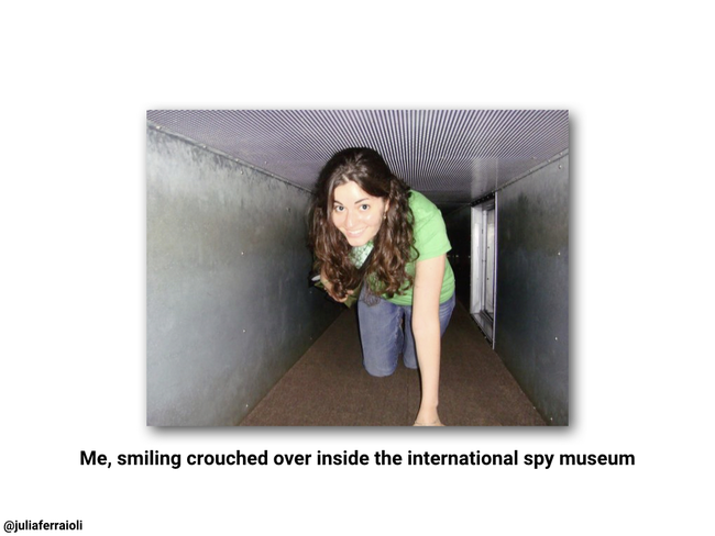 Photo of Julia crouched over inside the spy museum