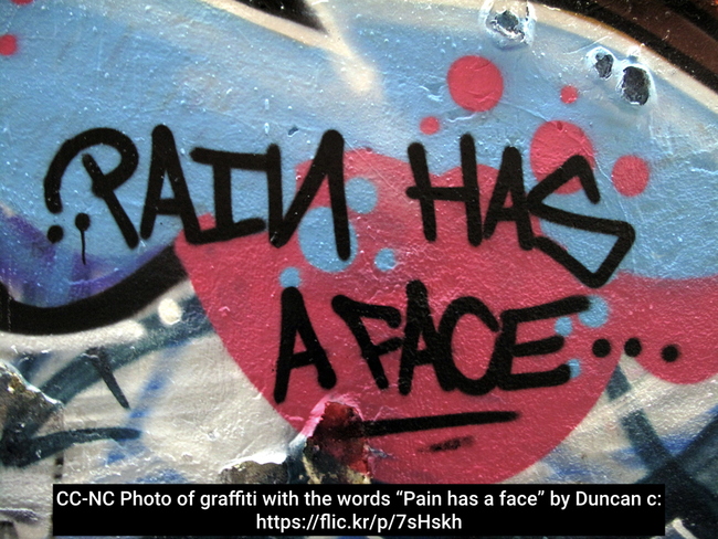 Photo of graffiti with the words &ldquo;Pain has a face&rdquo;