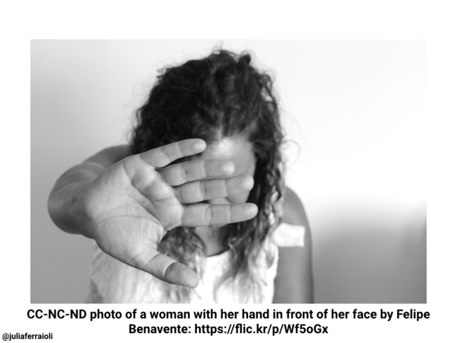 Photo of a woman with her hand in front of her face